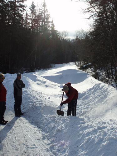 shoveling out a parking spot near Teapot Mountain in New Hampshire