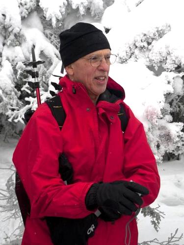 winter hiker on the summit of Mount Tecumseh in New Hampshire