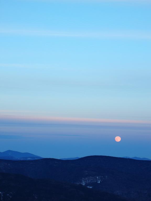 moonrise in December over Mount Kancamagus as seen from Mount Tecumseh in New Hampshire