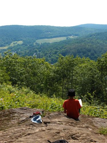 Anthony sketches the view from a near-summit ledge on Mount Tom at Woodstock in Vermont