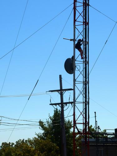 a college student climbs one of the antennas on the summit of Mount Tom in western Massachusetts