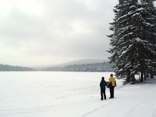 Marianne and Dick check out Little Diamond Pond in January near Tumble Dick Mountain in northern New Hampshire