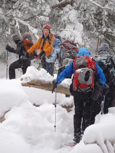 winter hikers crossing Little River on the way to North Twin Mountain in New Hampshire