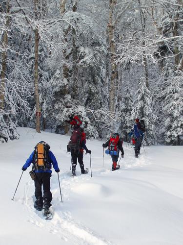 winter hikers cross Little River on the way to North Twin Mountain in New Hampshire