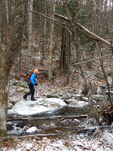 hiker on the trail to Terrace Mountain in New Hampshire