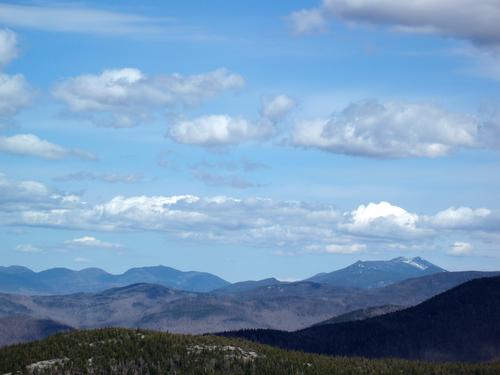 view of the White Mountains (Cannonballs and Cannon Mountain to the left; Franconia Ridge and Mount Lafayette to the right) from Dickey Mountain in New Hampshire