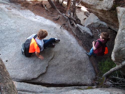 hikers descending a steep section of the Blueberry Ledge Trail on Mount Whiteface in the Sandwich Range in New Hampshire