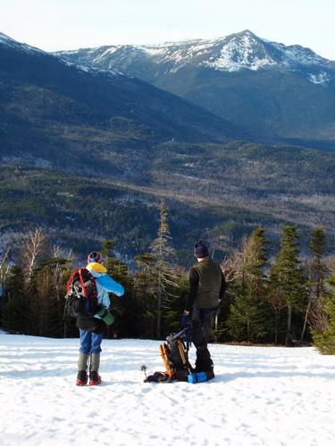 hikers on Wildcat Mountain in New Hampshire with Mount Adams in the background