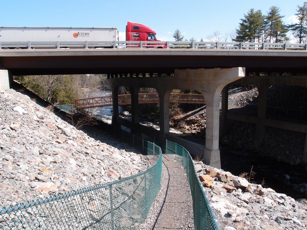 Everett Turnpike and pedestrian bridge crossing over the Souhegan River near Wildcat Falls at Merrimack in New Hampshire