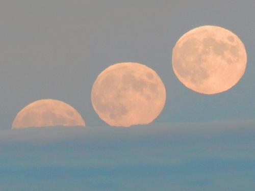 progressive moonrise (collage photo) as it rises at sunset above a low cloud layer, as seen from Winn Mountain in New Hampshire