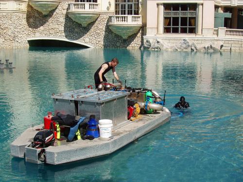 maintenance crew working on the orchestrated fountain in front of the Belagio casino at Las Vegas, Nevada