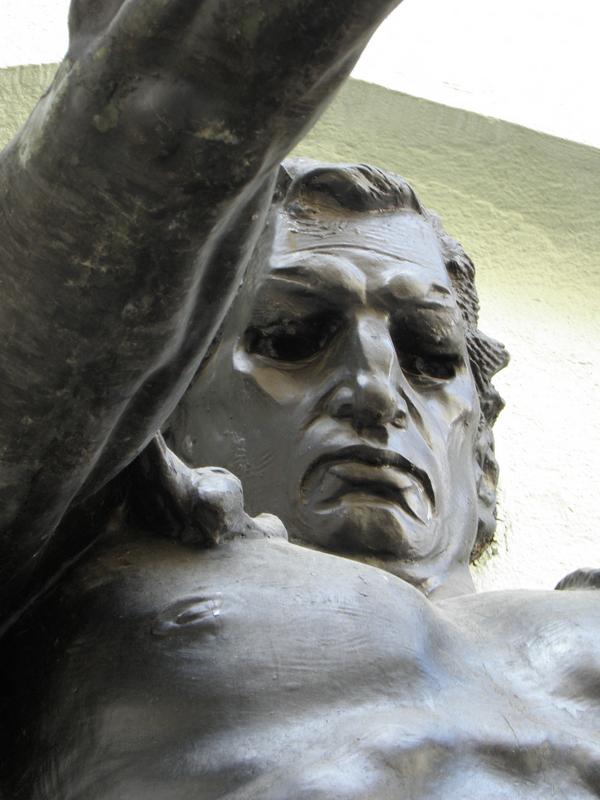 statue holding a lamp in front of the Prague Palace Hotel in the Czech Republic