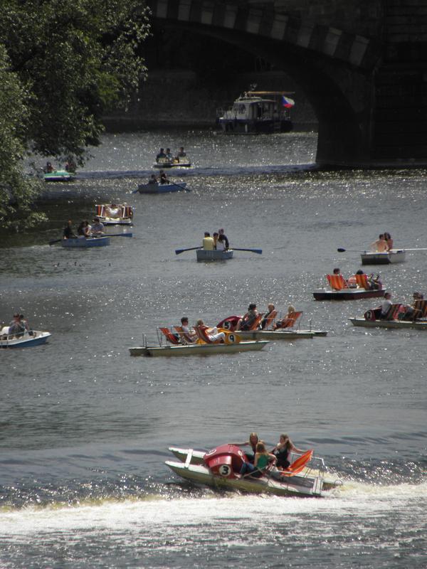 tourists playing in boats on Prague's Vltava River in the Czech Republic