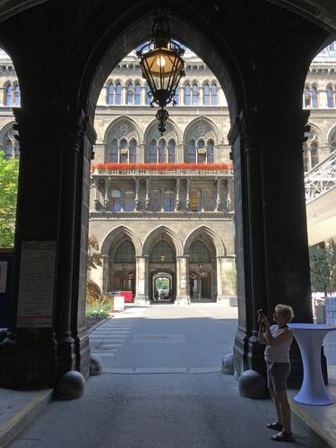 Andee takes a photo in an archway at City Hall in Vienna, Austria