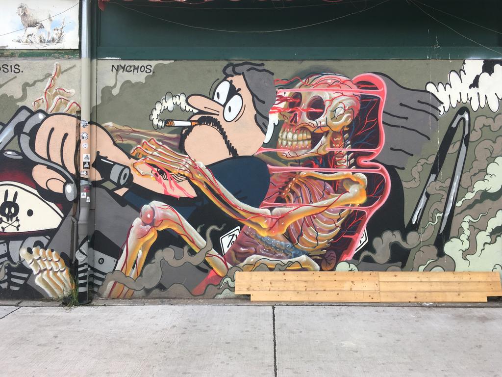 aggressive anti-smoking mural at an outdoor food market in Vienna, Austria